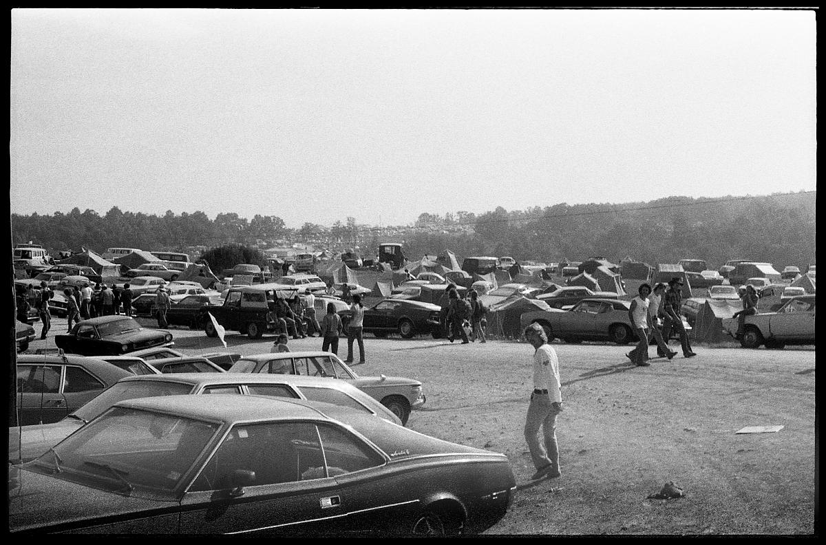 A03_054a.jpg -  As we got closer and started looking around for a place to camp, we got the feeling that we were in an improvised and autonymous community, which caused most of us to have flashbacks from the Woodstock movie.  By then there were about 150,000 people there and we figured that it wouldn't get much bigger than that... after all, Woodstock was three days, this was just a one-day concert, right?